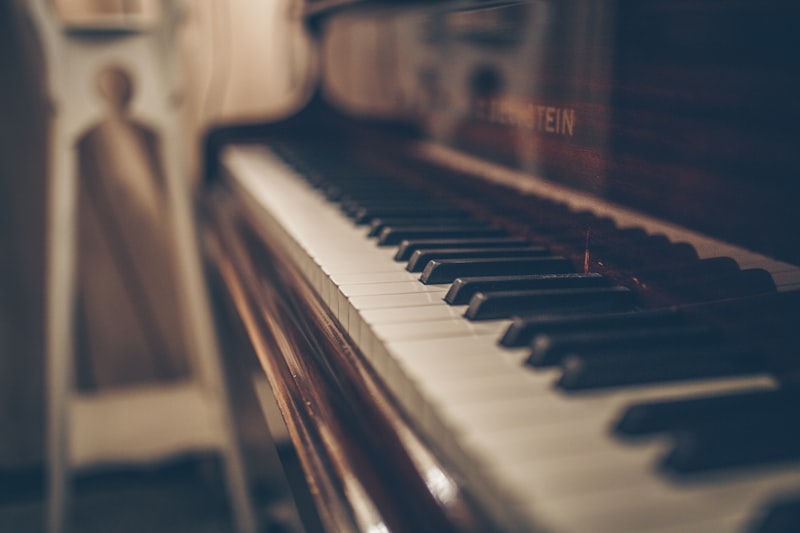 Warm wood Bechstein piano keyboard in studio light